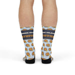 Back view of a model in the stuffie print Rhode Island socks showing black heels and blue stripes