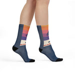 Model walking in On Island Time Block Island socks with orange and purple sunset stripes and black toes