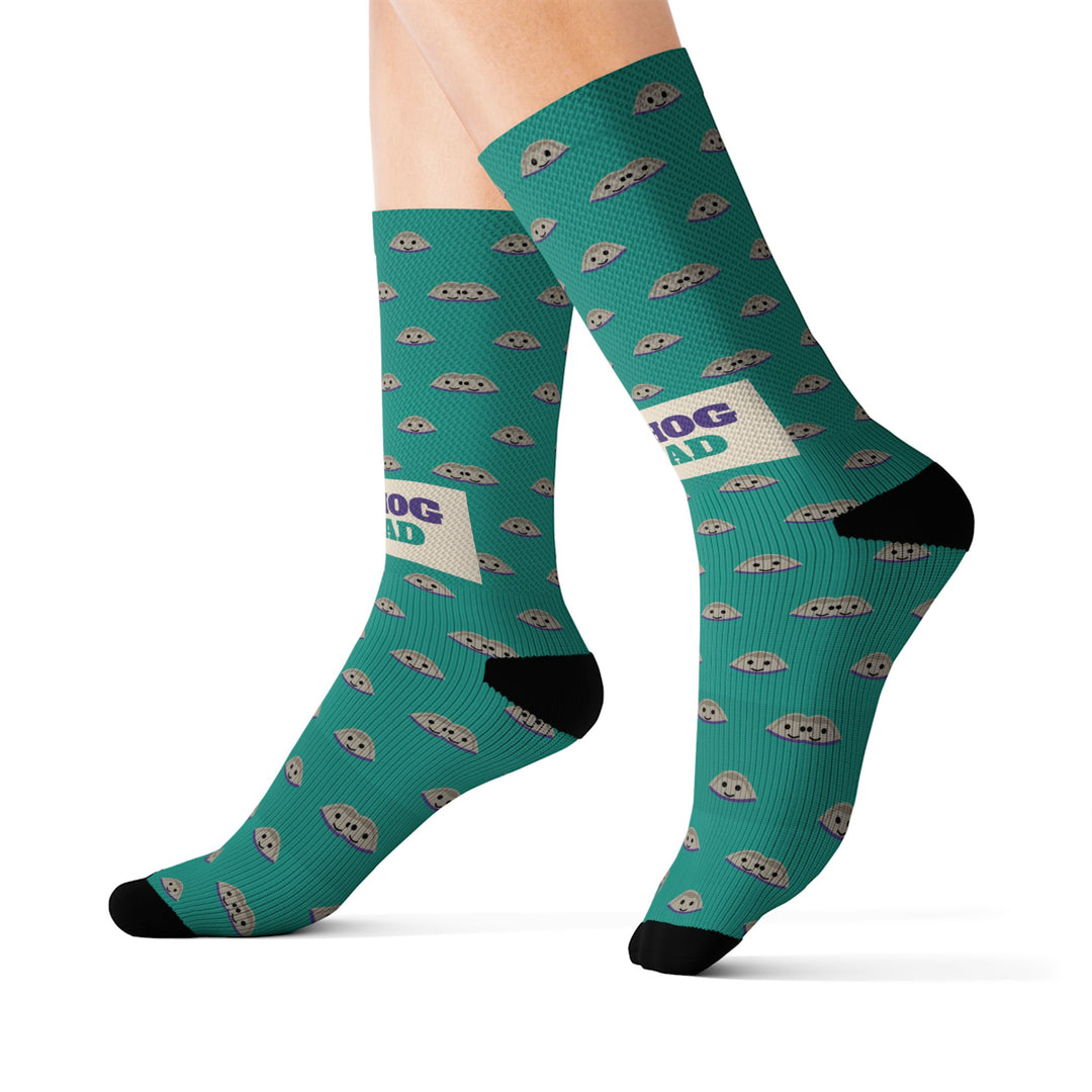 Size M Quahog Squad Rhode Island socks on leg forms, side view of the teal clam pattern with black heels and toes