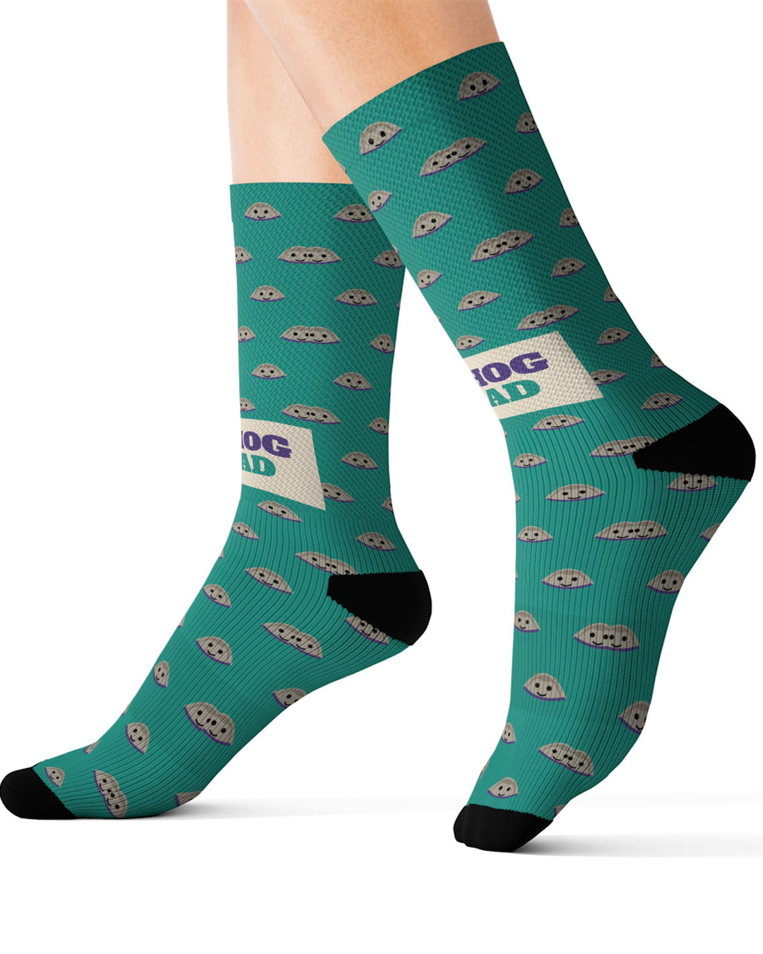 Size M Quahog Squad Rhode Island socks on leg forms, side view of the teal clam pattern with black heels and toes