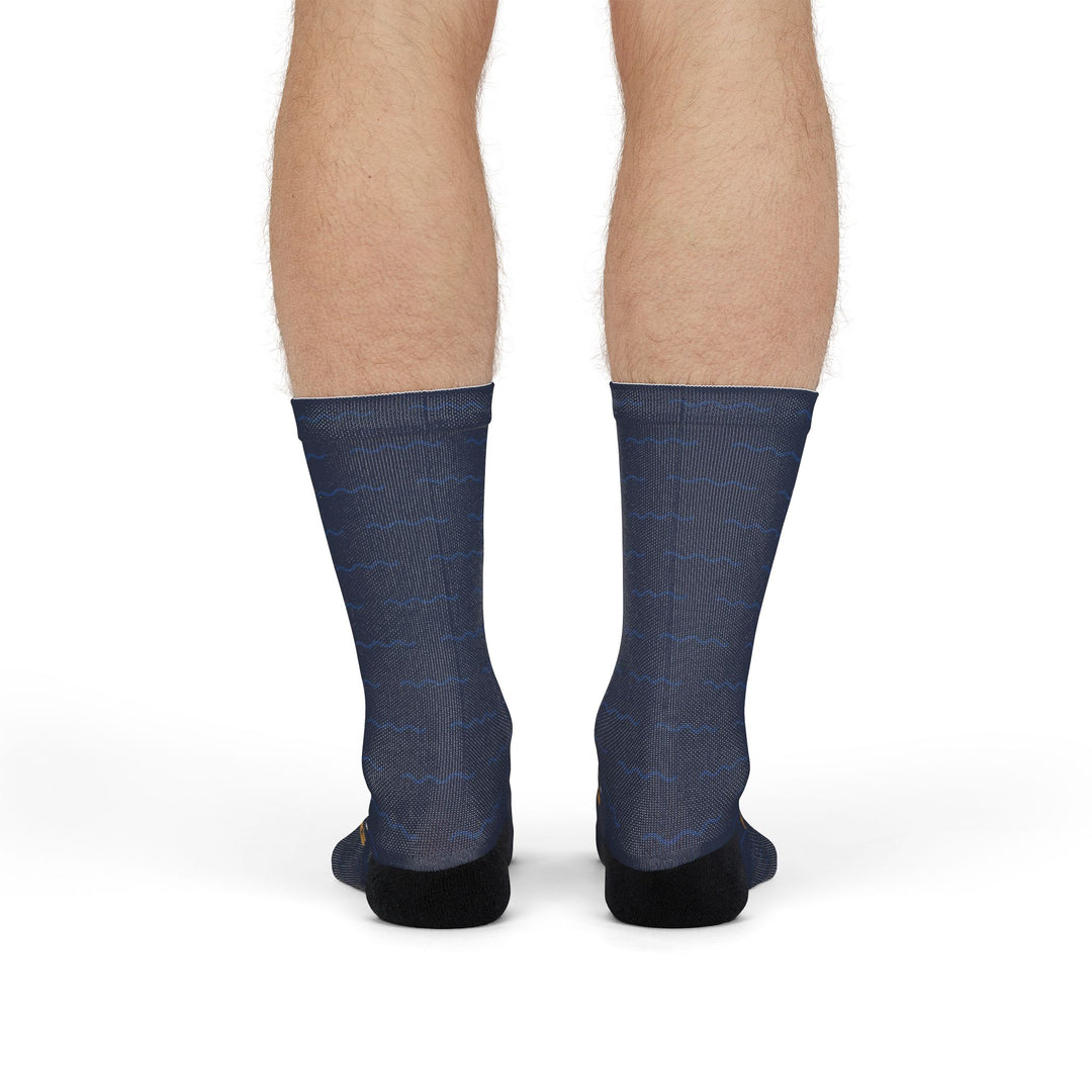 Front view of model standing in navy sailing crew socks with a white and gold compass rose