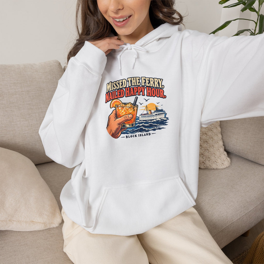 Smiling woman on a sofa wearing the white Missed the Ferry. Nailed Happy Hour. Rhode Island hoodie
