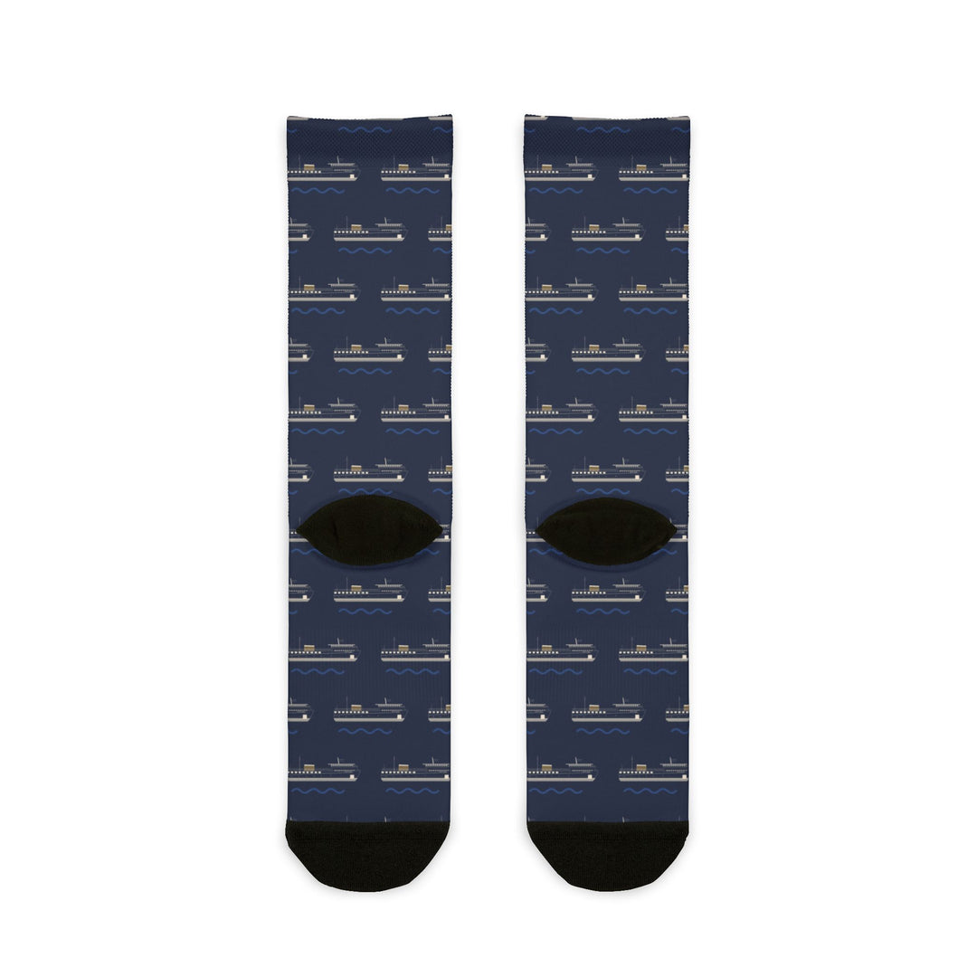 Back of Are We There Yet? ferry socks laid flat, navy repeating ferry pattern with black heels and toes
