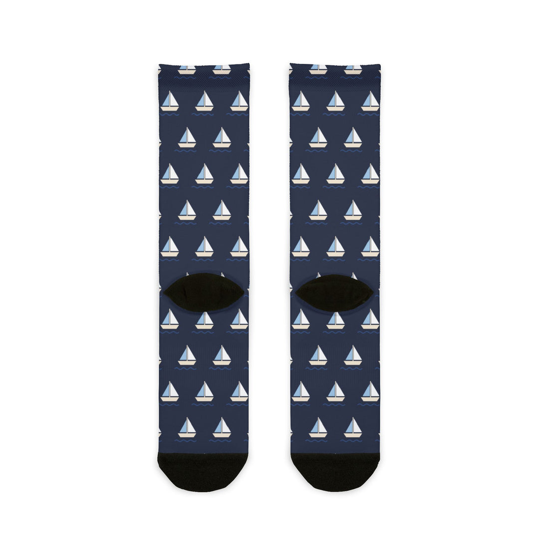 Back flat lay of navy Captain of the Couch socks showing black heels and an all-over white sailboat pattern