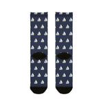 Back flat lay of navy Captain of the Couch socks showing black heels and an all-over white sailboat pattern