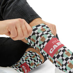 Close-up of hands pulling up I'll Have a Cabinet Rhode Island socks, I'll Have a Cabinet in white on the coral band