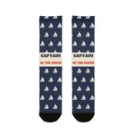 BlockBoundRI Captain of the Couch nautical crew socks, front flat lay of navy socks with white sailboats and cream band