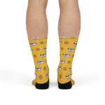 Front view of legs in yellow Swear Like a Sailor nautical crew socks with red band and cursing speech bubbles