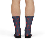 Front view of model standing in navy island time lobster socks with rows of red lobsters