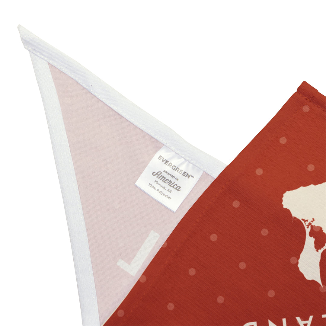 Close-up of the red Block Island dog bandana corner with white hem, care label and pale reverse side