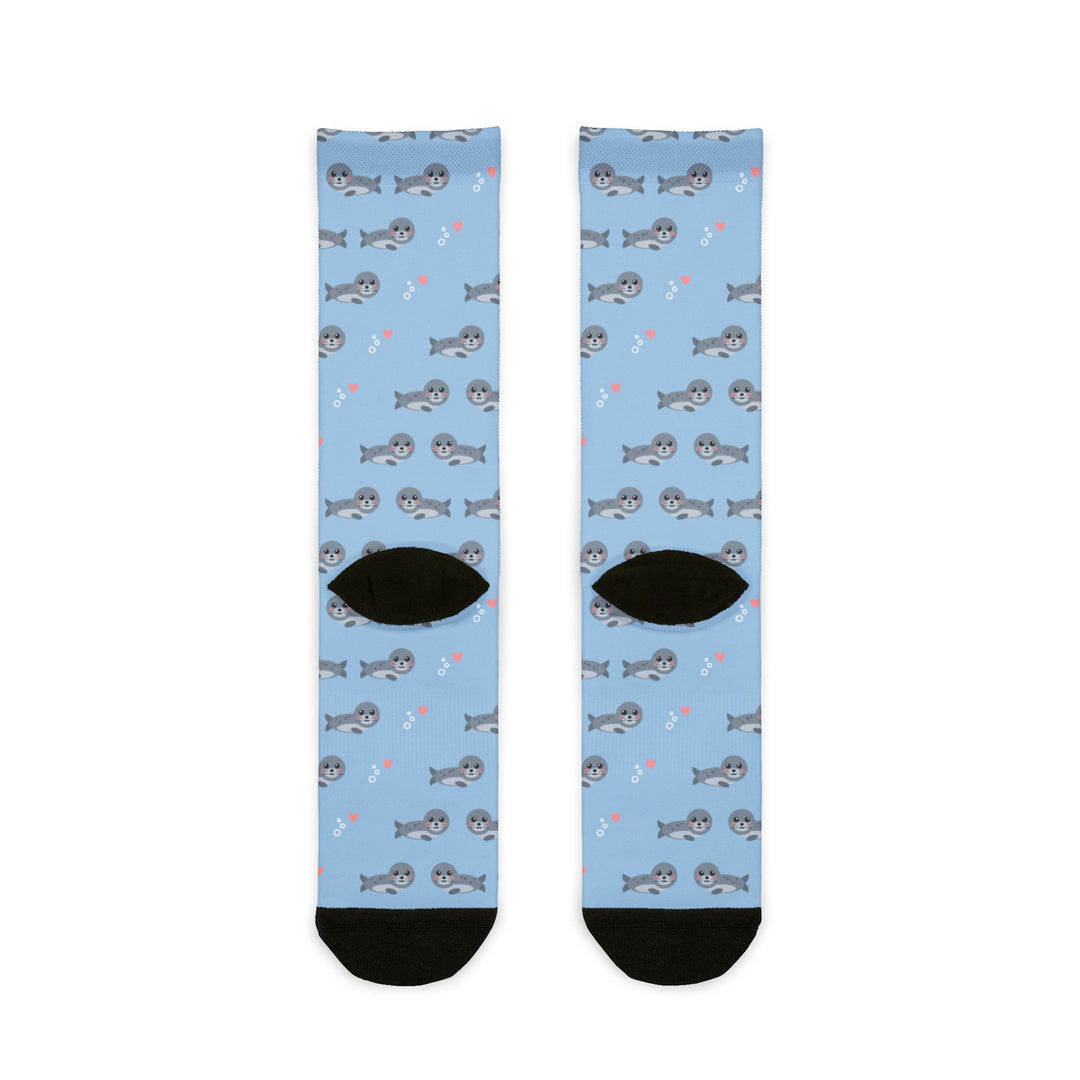Back of the light blue Seal of Approval funny beach socks laid flat, showing harbor seal print and black heels