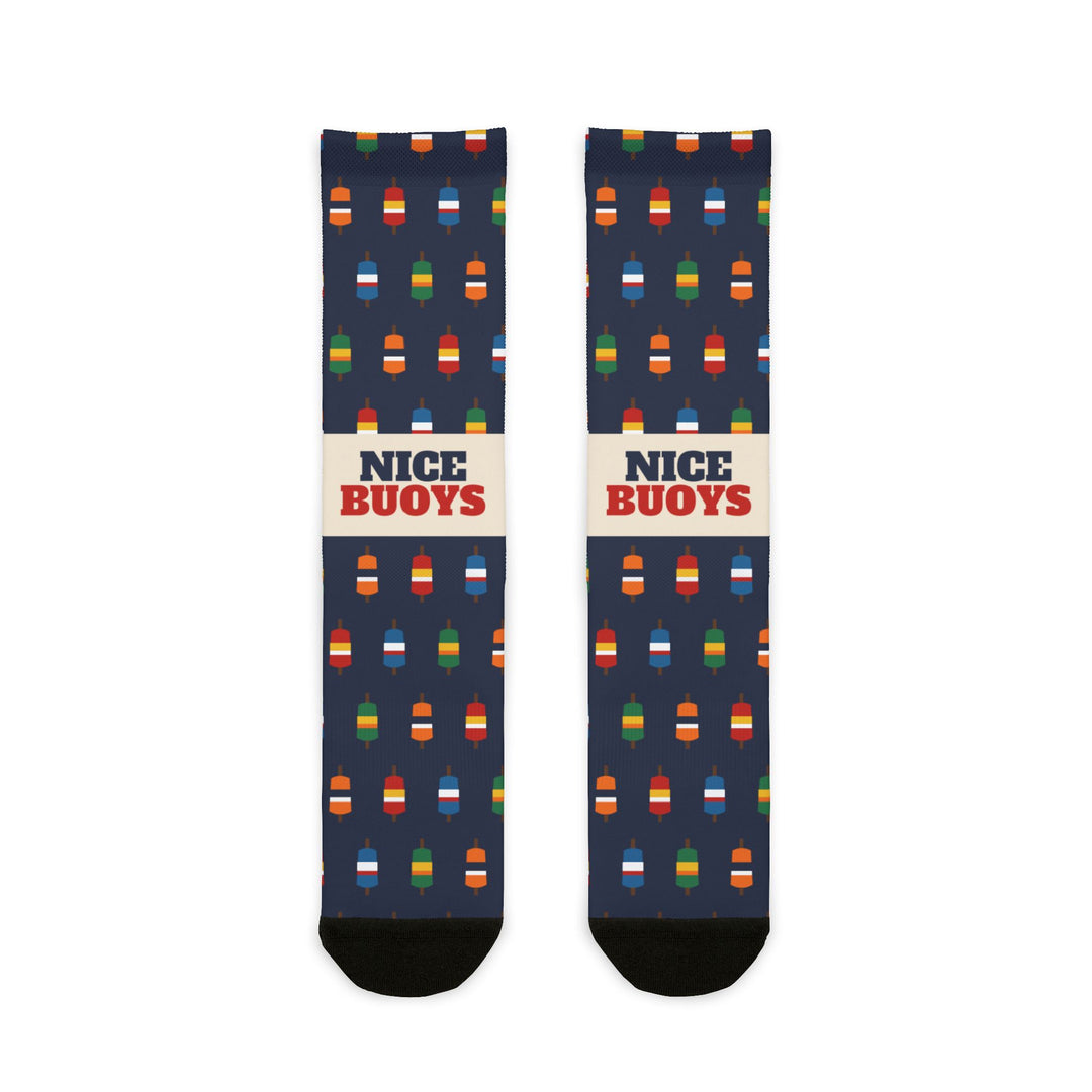 Nice Buoys funny Rhode Island socks in navy with multicolor lobster buoy print and red lettering on a cream band, flat lay