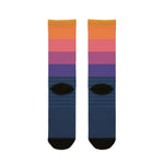 Back flat lay of sunset gradient sailboat socks in orange, pink and purple with navy foot and black heels