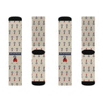 Two pairs of tan Nautical But Nice anchor socks laid flat, front and back with navy banner and red heart