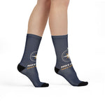 Model walking in navy Not Lost, Just Sailing socks with the compass rose at the ankle, side view
