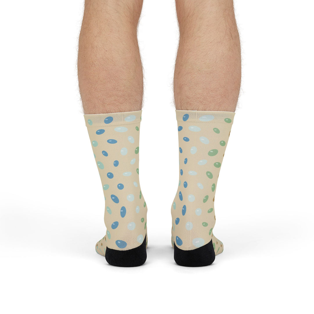Standing back view of sand beach socks with scattered sea glass pattern on both calves