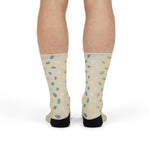 Standing back view of sand beach socks with scattered sea glass pattern on both calves