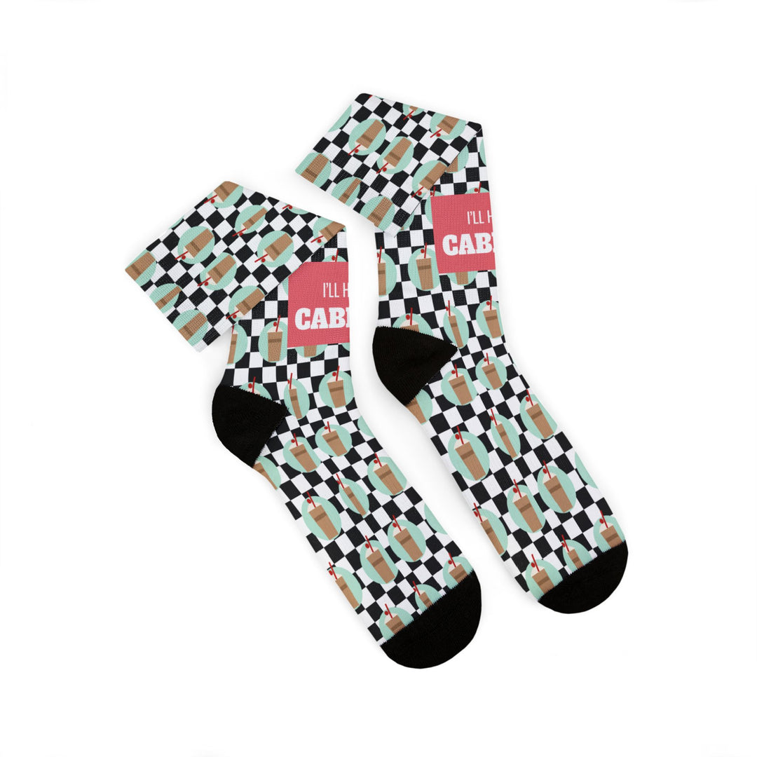 Two I'll Have a Cabinet socks folded and overlapping, black heels and toes on mint, tan and black checks, funny beach socks