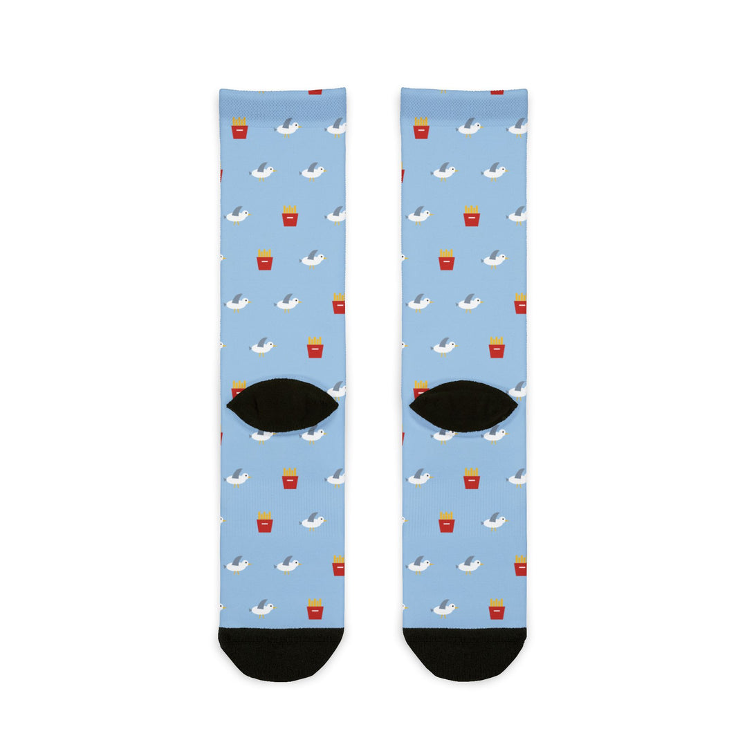 Back flat lay of light blue seagull socks with red french fry cartons, black heels and black toes