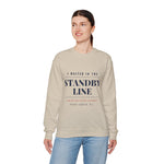 Woman in jeans wearing the sand I Waited in the Standby Line Block Island crewneck, front view