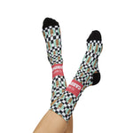 Raised crossed legs in I'll Have a Cabinet coffee cabinet socks, black heels up and the coral band on one ankle