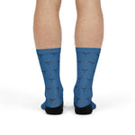 Model standing in blue Whale Hello There ocean socks, back view of the whale tail pattern and black heels