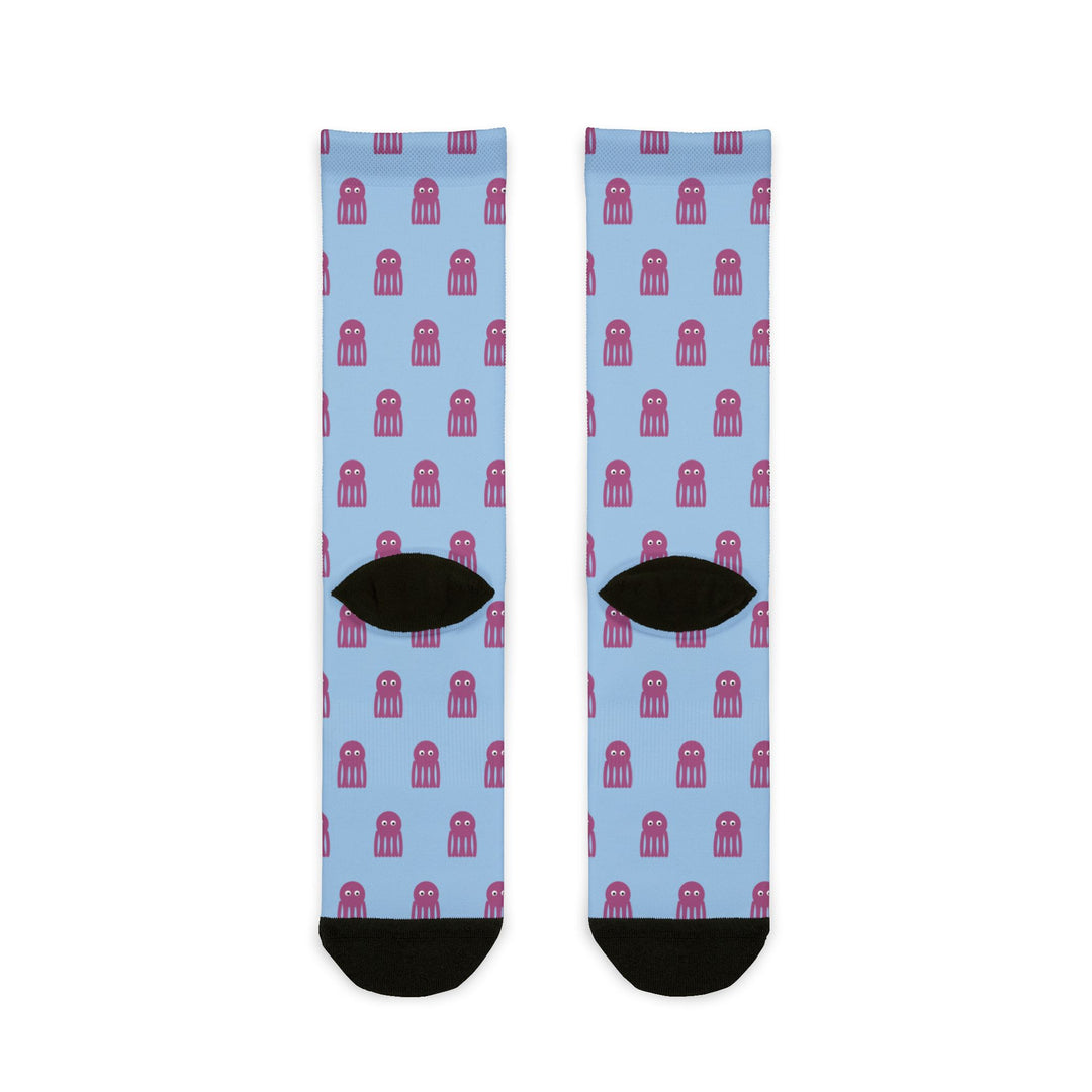 Back of the light blue I'd Need 4 Pairs octopus crew socks laid flat, showing black heels and toes