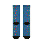 Back flat lay of blue boater socks dotted with red and green channel buoys, black heels and toes