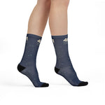 Model standing in navy 401 State of Mind Rhode Island socks, angled view of the cuff and black heels