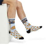 Seated model's crossed legs in Stuff It. The Rhode Island Stuffie socks with stuffie print and black toe