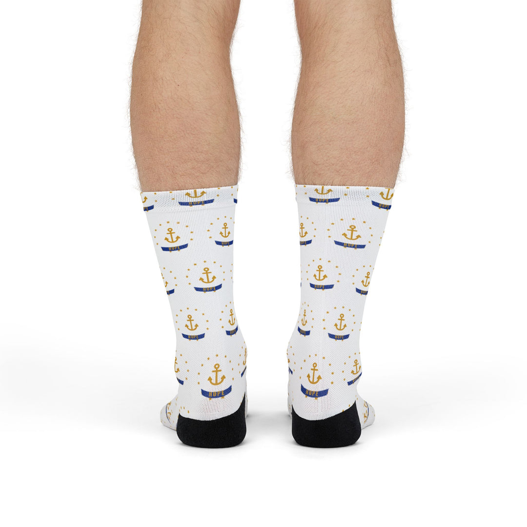Front view of legs in white Smallest State Biggest Mouth Rhode Island socks with a gold star-ringed anchor print