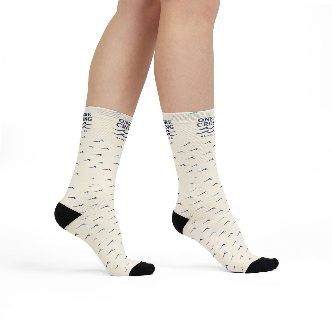Model standing in off-white One More Crossing Block Island wave socks with black toes, side view