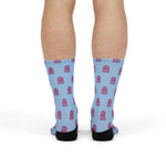Front view on standing model of light blue funny beach socks covered in pink octopuses