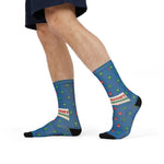 Model in navy shorts mid-stride showing the Red Right Returning band on blue buoy crew socks