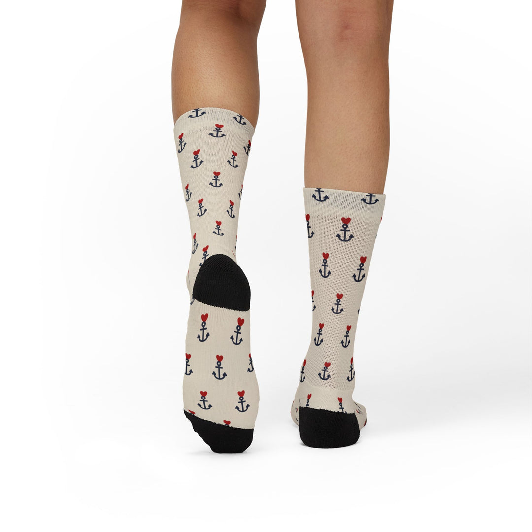 Back view of tan anchor print sailor socks on a standing model, black heels and navy anchors with red hearts