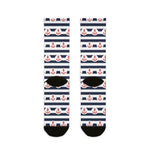 Back of the navy-striped anchor socks laid flat showing black heels and toes, red anchor nautical crew socks