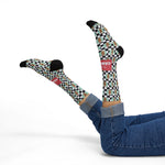 Model in blue jeans lying back, legs kicked up in I'll Have a Cabinet coffee milkshake Rhode Island socks with black toes