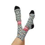 Model's legs crossed in the air wearing I'll Have a Cabinet Rhode Island socks, checkered soles and coral band in view