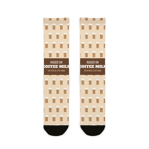 BlockBoundRI Raised on Coffee Milk Rhode Island socks, cream crew socks with brown band and coffee milk icons, flat lay