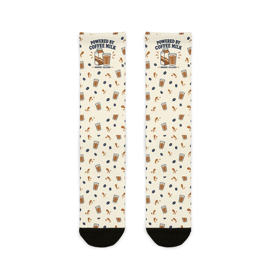 Flat lay of cream Powered by Coffee Milk Rhode Island socks with milk carton, coffee cup and bean pattern