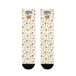 Flat lay of cream Powered by Coffee Milk Rhode Island socks with milk carton, coffee cup and bean pattern