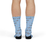Front view of legs in light blue harbor seal funny beach socks with black heels and toes