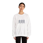 Front view of a woman in the white One More Crossing crewneck with navy waves, Block Island sweatshirt