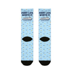 Back of the Ferry Late. Worth It. Block Island crew socks laid flat, showing black heels and light blue all-over print