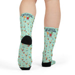 Rear view of model standing in mint green Block Island cocktail socks with black heels