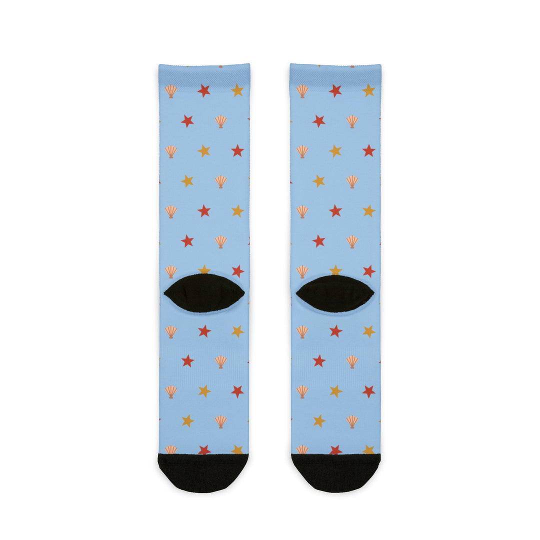 Back of light blue Beachcomber starfish socks showing black heels, Rhode Island socks flat lay
