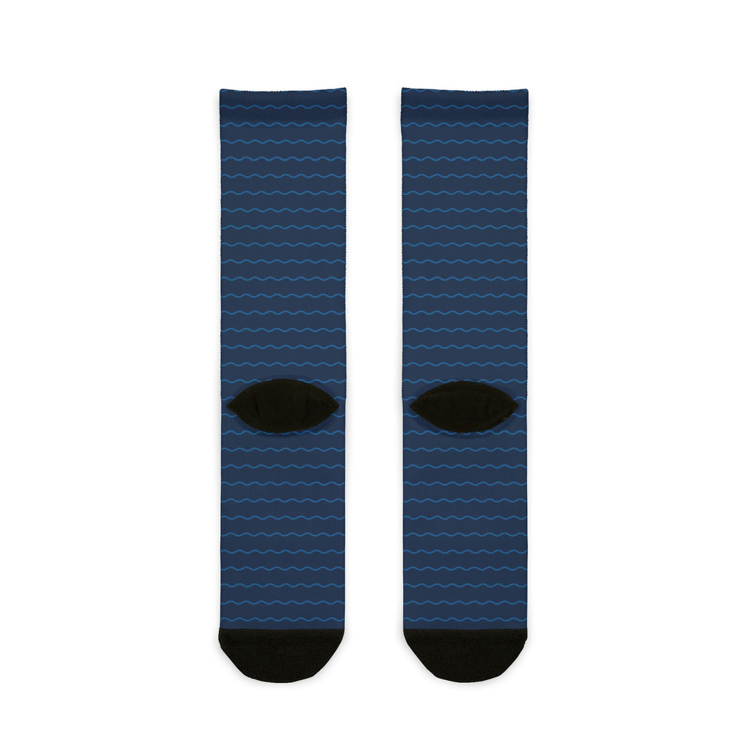 Back of the On Island Time nautical crew socks showing the navy wave pattern and black heels, flat lay