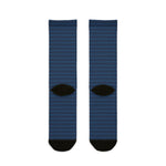 Back of the On Island Time nautical crew socks showing the navy wave pattern and black heels, flat lay