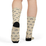 Rear view of a model in cream My Legs Biked the Bluffs bike crew socks with black heels
