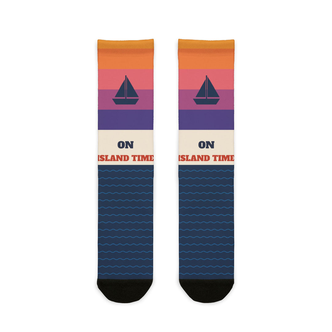 BlockBoundRI On Island Time Block Island socks with sunset stripes, navy sailboat and navy wave pattern, flat lay